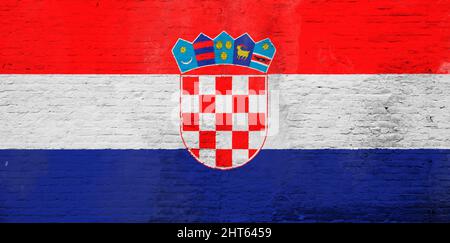 Full frame photo of a weathered flag of Croatia painted on a plastered brick wall. Stock Photo