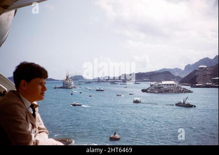 Young man looking out over the harbour from a ship in Aden, Yemen 1956 Stock Photo