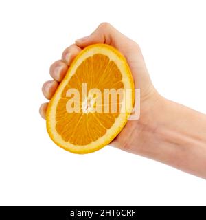 Squeeeze. Cropped studio shot of a person squeezing half an orange in their hand. Stock Photo
