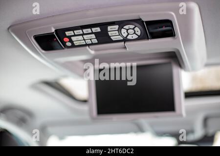 screen m multimedia system control panel on the ceiling of a modern car. close-up Stock Photo