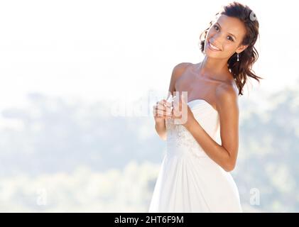 Happiest day of her life. A beautiful bride smiling at the camera. Stock Photo