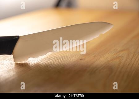 old broken ceramic knife on wooden table Stock Photo