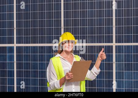 Woman engineer happy with the results of renewable energies Stock Photo