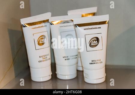 Large group of plastic soap and shampoo containers in hotel bathroom Stock Photo