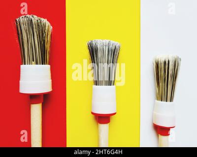 Close-up of brushes of different sizes isolated on colored backgrounds Stock Photo
