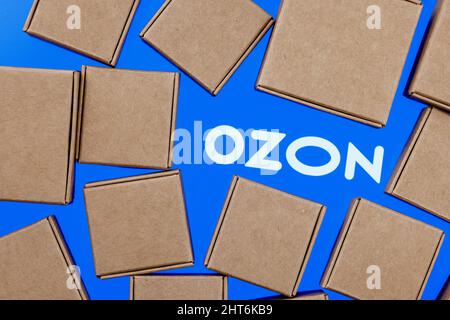 Ozon is Russian e-commerce company. Ozon logo on a white background surrounded by parcel boxes. Stock Photo