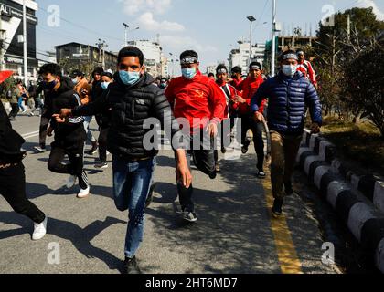 Demonstrators run for cover as riot police charges towards them during a protest against the $500 million U.S. infrastructure grant under the Millennium Challenge Corporation (MCC) near the parliament in Kathmandu, Nepal February 27, 2022. REUTERS/Navesh Chitrakar