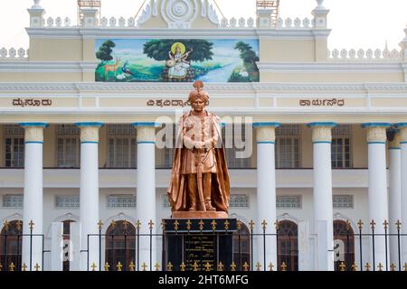 105 years historic University of Mysore Crawford Hall administrative block with the statue of Maharaja Krishnaraja Wodeyar, Mysuru, Karnataka, India Stock Photo