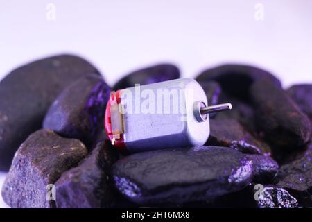 Small electric dc motor or called as toy dc motor on a stone Stock Photo