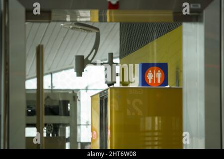 Interior of Dubai International Airport terminal with toilet sign at departure gate. No people. Stock Photo