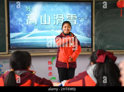 (220227) -- CHENGDU, Feb. 27, 2022 (Xinhua) -- Member of the 'Dieyun' ski team Wang Xinyue shares her experience in skiing with classmates at the special education school in Xindu District of Chengdu, southwest China's Sichuan Province, Feb. 25, 2022. When seeing the boys and girls skiing down the slope, no one will realize they are anything different from other ski-loving youngsters until noticing their coach communicating with them mainly through writing and gesturing.   All of the 15 members of this ski team are students from the special education school in Xindu District of Chengdu, capita Stock Photo