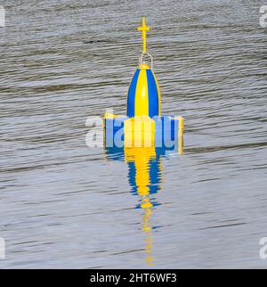 Blue and yellow marine wreck navigation buoy Stock Photo - Alamy