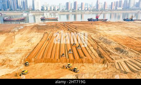 NANCHANG, CHINA - FEBRUARY 27, 2022 - Excavators and bulldozers repair exposed landmass in jiangzhou at the construction site of ecological restoratio Stock Photo