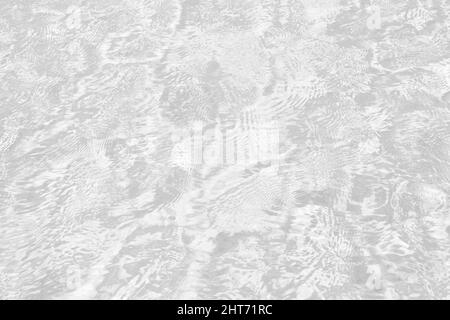 Closeup of desaturated transparent clear calm water surface texture with splashes and bubbles. Trendy abstract nature background. Stock Photo