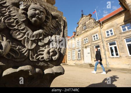 27 February 2022, Saxony-Anhalt, Blankenburg: A man walks along the small castle in the baroque terrace garden below the large castle in Blankenburg. The well-kept area is laid out on four levels with twelve sandstone sculptures symbolizing the signs of the zodiac. The terraced garden is one of the 12 most beautiful gardens in the state of Saxony-Anhalt. As a princely pleasure garden, this park was built around 1725. Photo: Matthias Bein/dpa-Zentralbild/dpa Stock Photo