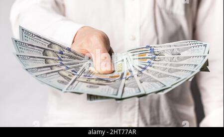 Businessman hand closeup showing one hundred dollar bills. Business income concept. High quality photo Stock Photo