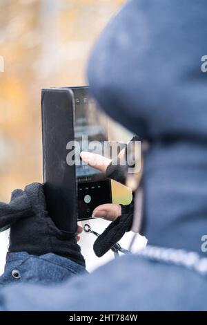 Vertical shot of a person taking photo on his phone Stock Photo