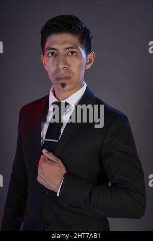Portrait of an Asian tango dancer against a gray wall Stock Photo