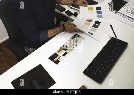 Closeup of a young male architect hands working on a project in his office Stock Photo