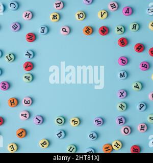 Cyrillic letters colorful buttons square on a pastel blue background. Russia, Eastern Europe conceptual backdrop. Stock Photo
