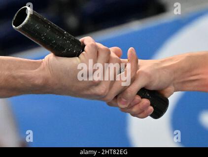 Leipzig, Germany. 27th Feb, 2022. A baton is handed over during the men's 4x200-meter relay race at the German Indoor Athletics Championships in the Arena Leipzig. The championships will take place on February 26 and 27. Credit: Martin Schutt/dpa-Zentralbild/dpa/Alamy Live News Stock Photo