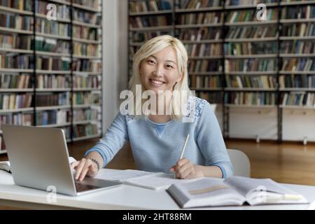 Portrait of smiling beautiful Japanese female student. Stock Photo