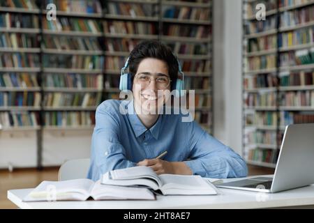 Smiling motivated millennial Jewish male student studying in library. Stock Photo