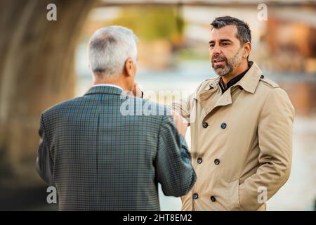 Two amazing senior businessmen are talking to each other, close up Stock Photo