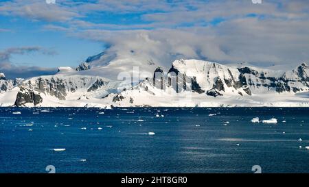 A scenic view of the Palmer Archipelago in Gerlache Strait in Antarctica under a blue cloudy sky Stock Photo