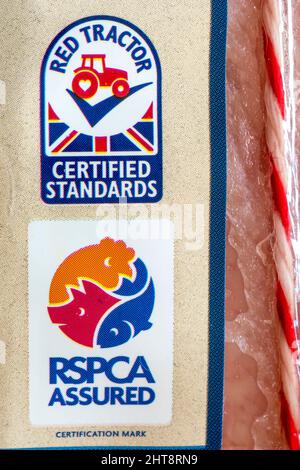 RSPCA Assured and Red Tractor Certified Standards labels on a shrink wrapped joint of meat in a supermarket. Stock Photo