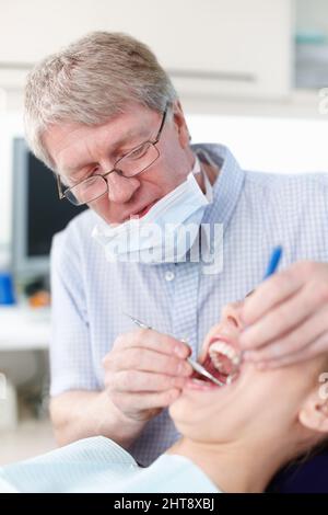 For better teeth. Portrait of female patient with dentist working on her teeth. Stock Photo
