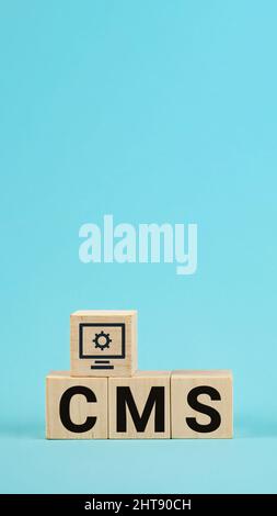 CMS acronym on woodblock cubes blue background, Frequently asked Stock Photo