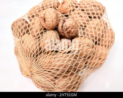 Healthy walnuts on the net for people and animals Stock Photo