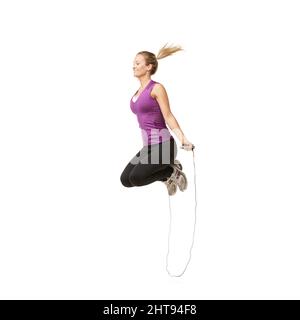 Wheeee. An attractive young woman skipping with a smile on her face. Stock Photo