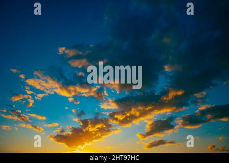 Dramatic sky at sunset. Partly cloudy sky at sundown. Stock Photo
