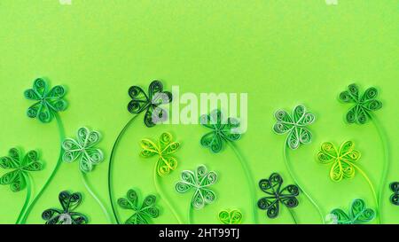 Shamrock leaves in quilling technique on a green background with copy space. St. Patrick's day sale promotion banner. St. Patrick's Day background wit Stock Photo