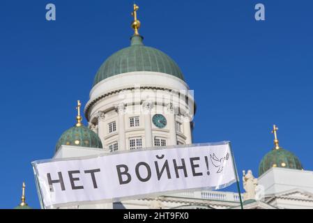 Helsinki, Finland - February 26, 2022: Demonstrator in a rally against Russia’s military actions and occupation in Ukraine carrying sign No to war. Stock Photo