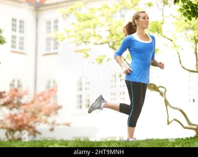 Getting fit. Attractive young woman out for a run. Stock Photo