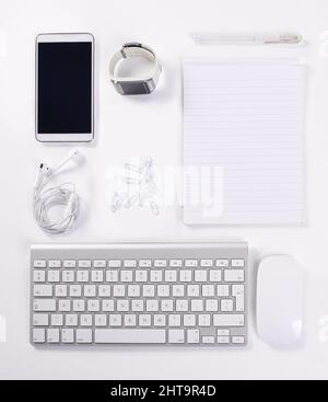 Equipped for productivity. A high angle view of various office equipment items and digital devices. Stock Photo