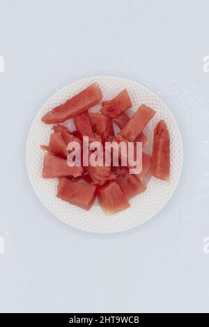 A closeup of Watermelon Chunks on a white plate Stock Photo