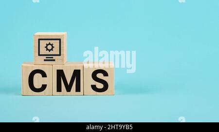 CMS acronym on woodblock cubes blue background, Frequently asked Stock Photo