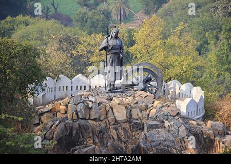Statue of a soldier holding a spear standing near cannon on hillock near Pratap Smarak, Rajasthan. Stock Photo