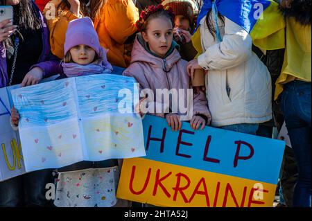 Two little girls are holding placards in support of Ukraine, during the massive demonstration against Putin's invasion of Ukraine, organized in Amsterdam, on February 27th, 2022. After Putin's decision to attack Ukraine, several protests were organized in the center of the city, on the same day to show their support with the Ukrainian people. The Ukrainian community, the Russian community, and several non-governmental organizations in The Netherlands accompanied by thousands of people gathered at the Dam square to protest against Putin and the war in Ukraine.(Photo by Romy Fernandez/Sipa USA) Stock Photo