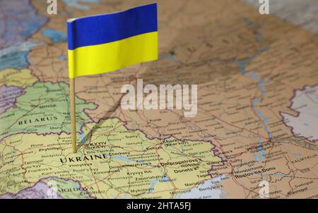 The Ukrainian flag stuck in the center of the country. Neighboring Russia and Belarus are prominent. Atlas or world map showing location of the count Stock Photo