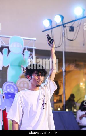 Bangkok, Thailand. 27th Feb, 2022. The rap artist aka 3Bone sings about social issues while performing art with color on paper. (Photo by Adirach Toumlamoon/Pacific Press) Credit: Pacific Press Media Production Corp./Alamy Live News Stock Photo