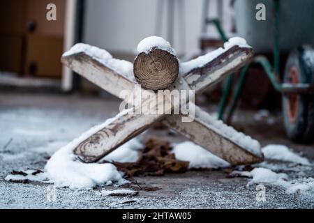 A selective focus of a wooden border parked and covered with new snow Stock Photo