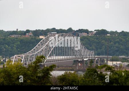 View of Julien Dubuque Bridge against trees and cloudy sky, Dubuque city, Iowa, United States Stock Photo