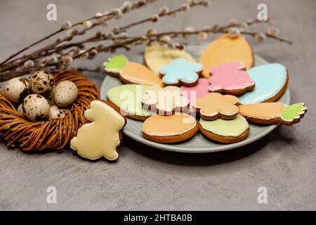 Easter still life with cookies, a nest and a bundle of willow twigs. Stock Photo