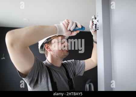 Man installing wooden door hinges Stock Photo