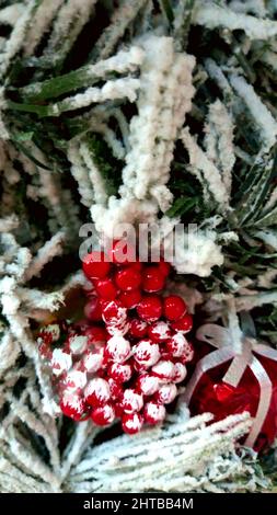 A vertical macro shot of various Christmas decorations on a Christmas tree Stock Photo
